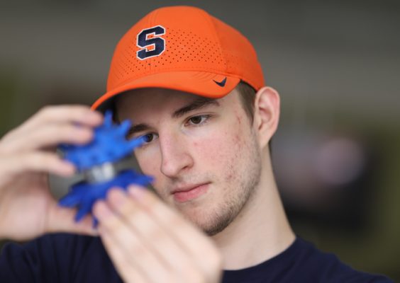 A man in an Orange Syracuse hat participating in Invent at SU.