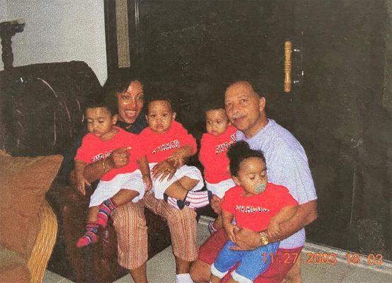 childhood family portrait of Capdeville quadruplets wearing Syracuse t-shirts with their parents