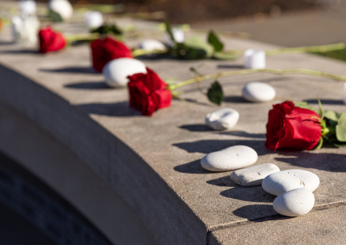 Roses and stones on the Wall of Remembrance
