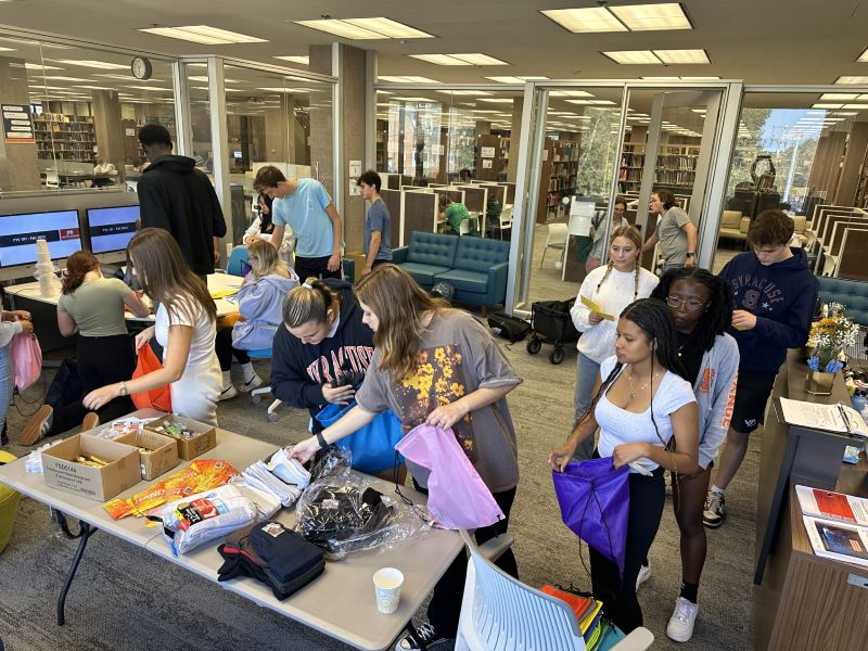 students assemble items into packs for donation