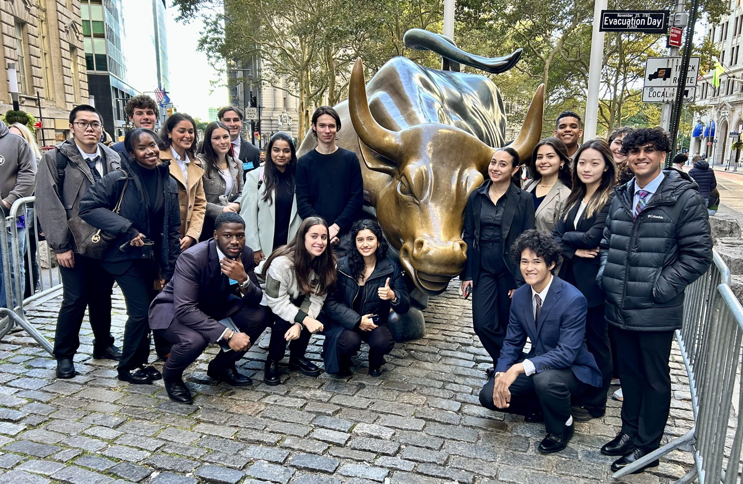 Students pose for a photo on Wall Street