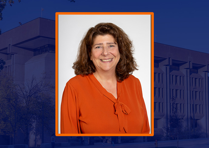 headshot of Melinda Dermody with an orange frame against a blue backdrop with Bird Library behind it