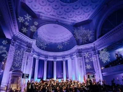 Choir performing in Hendricks Chapel with snowflakes projected on the ceiling