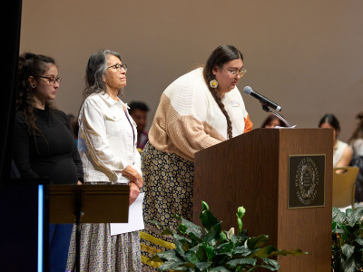 Two women give Native American blessing at the International Thanksgiving Dinner