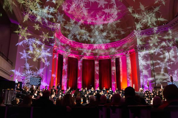 musicians perform in Hendricks Chapel during the annual Holiday at Hendricks event amidst a festive lights display