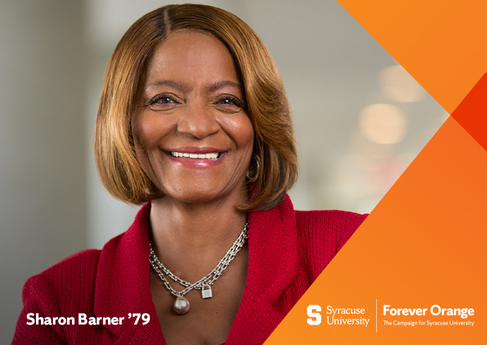 A woman smiles for a headshot while wearing a red jacket. The words Sharon Barner are on the bottom left, and Syracuse University and the Forever Orange Campaign are on the lower right.