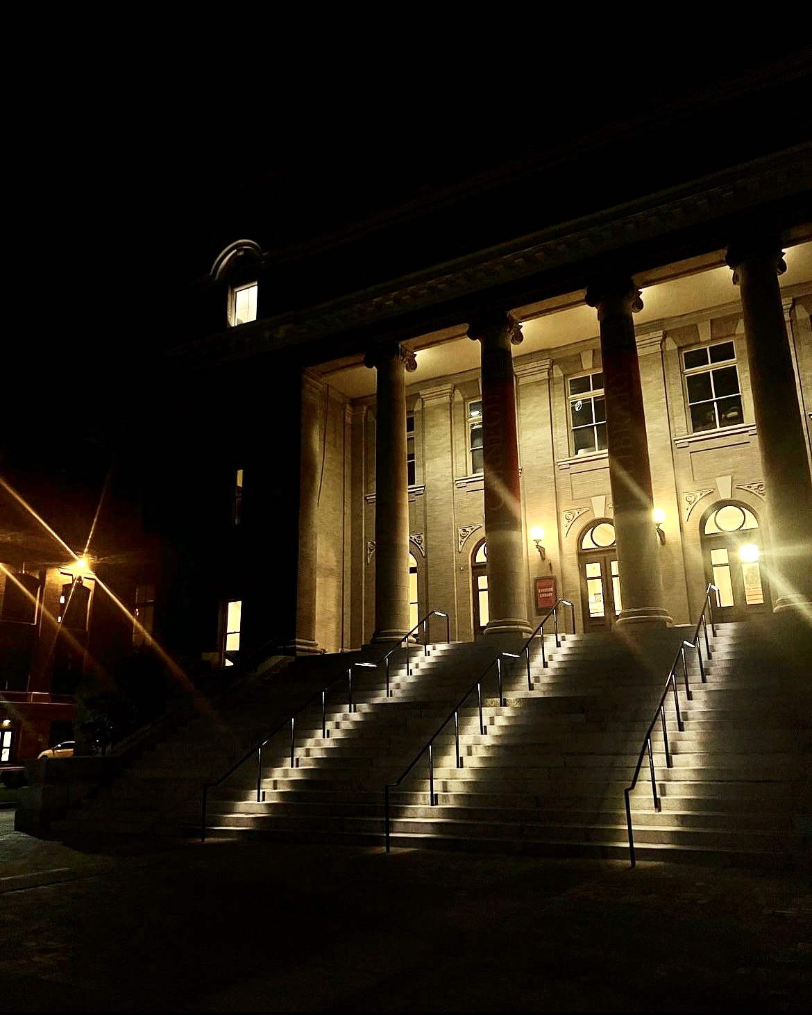 Night time photo of Carnegie Library with the lights on.