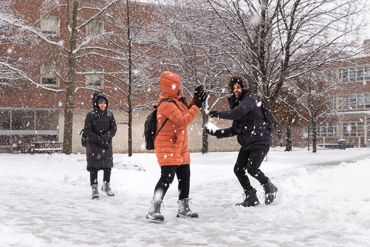 students on campus having a snowball fight