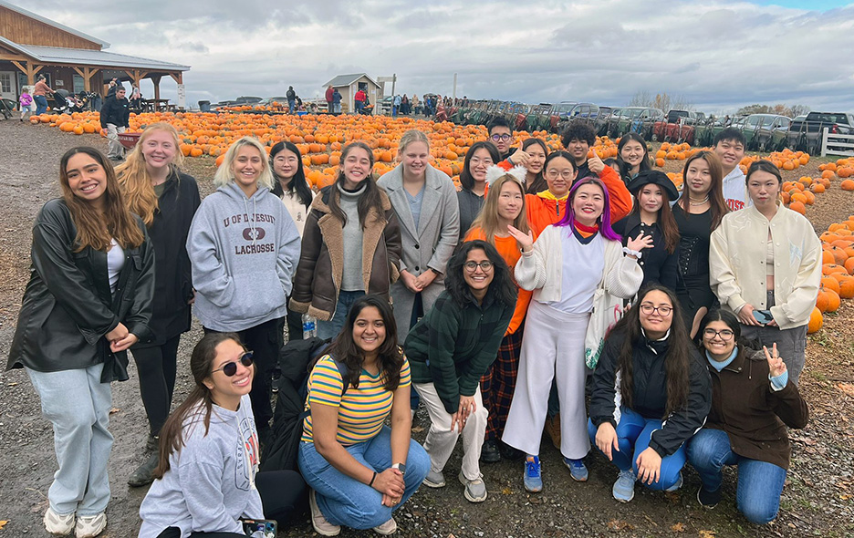 students gather together for a photo at a local pumpkin patch
