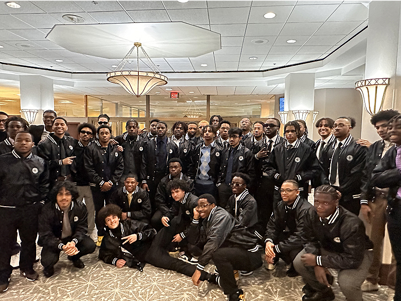 A group of students celebrate their 2023 Men of Color Initiative Induction Ceremony.