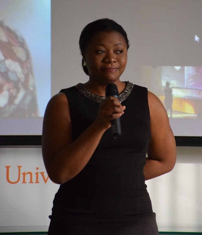 Tosin Alabi speaks into a microphone at the Afropreneurship Panel, Networking and Pitch competition
