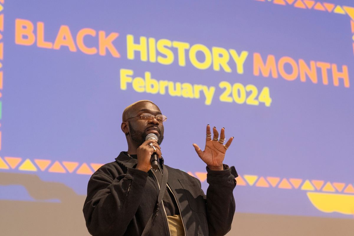 A presenter talks to students. Accompanying graphic reads Black History Month February 2024.