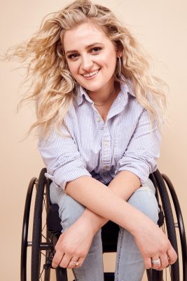 Women sitting in a wheel chair smiling
