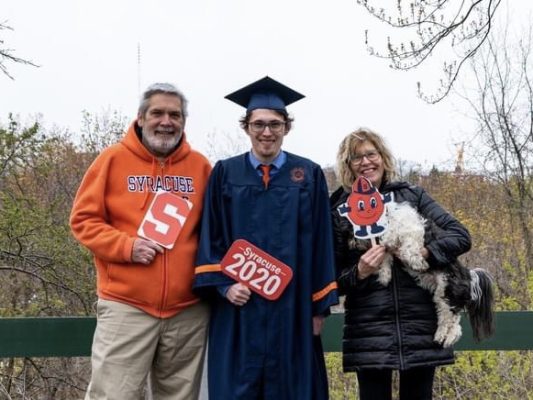Bobby Pangborn, center, celebrates his graduation with his parents.