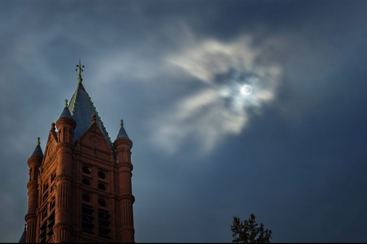 The exterior of Crouse College with the total solar eclipse occurring.