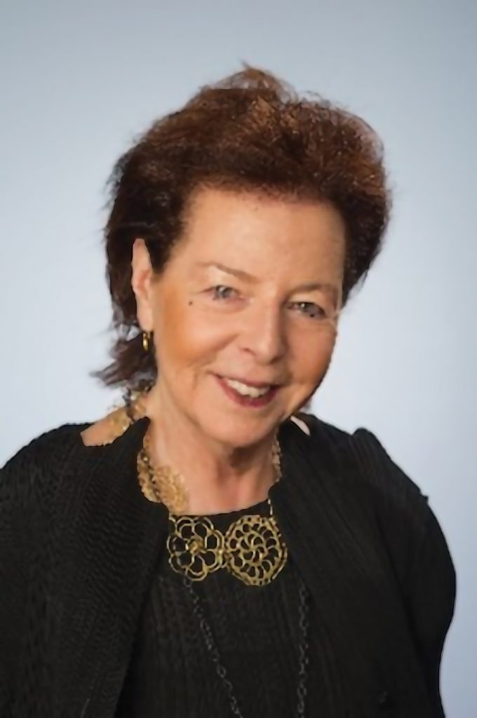 A woman smiles while posing for a headshot.
