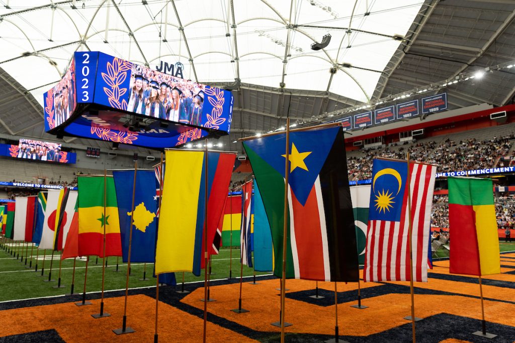 Flags from different countries on the field of the JMA Wireless Dome during Commencement