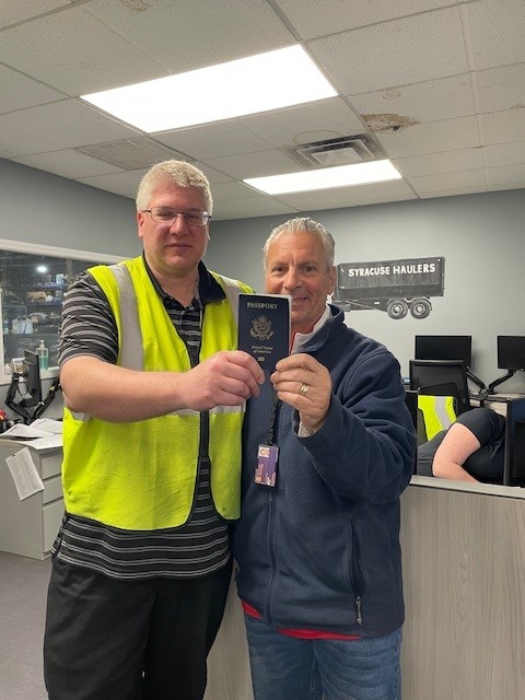 Steve Ruge and Joe Lore with a student's located passport