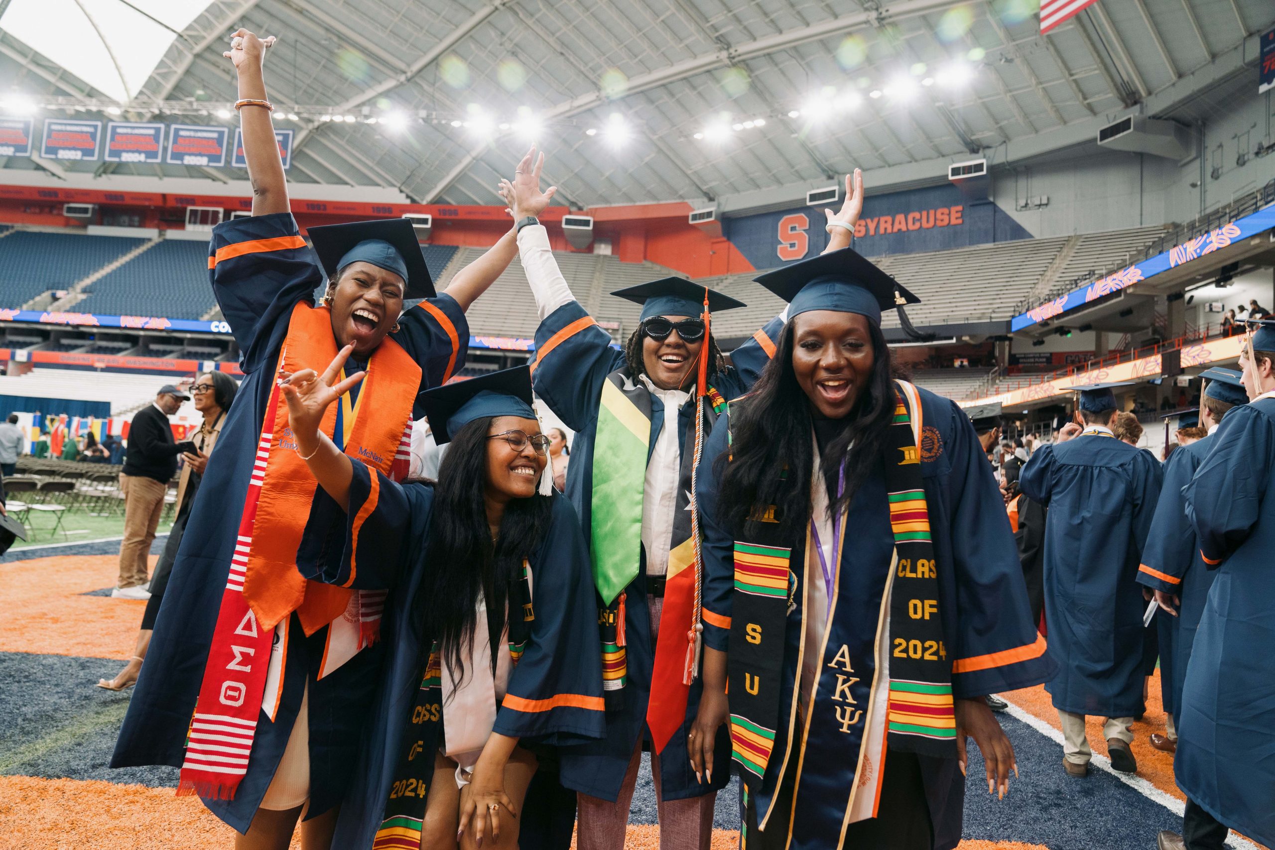 Four students pose together after Commencement