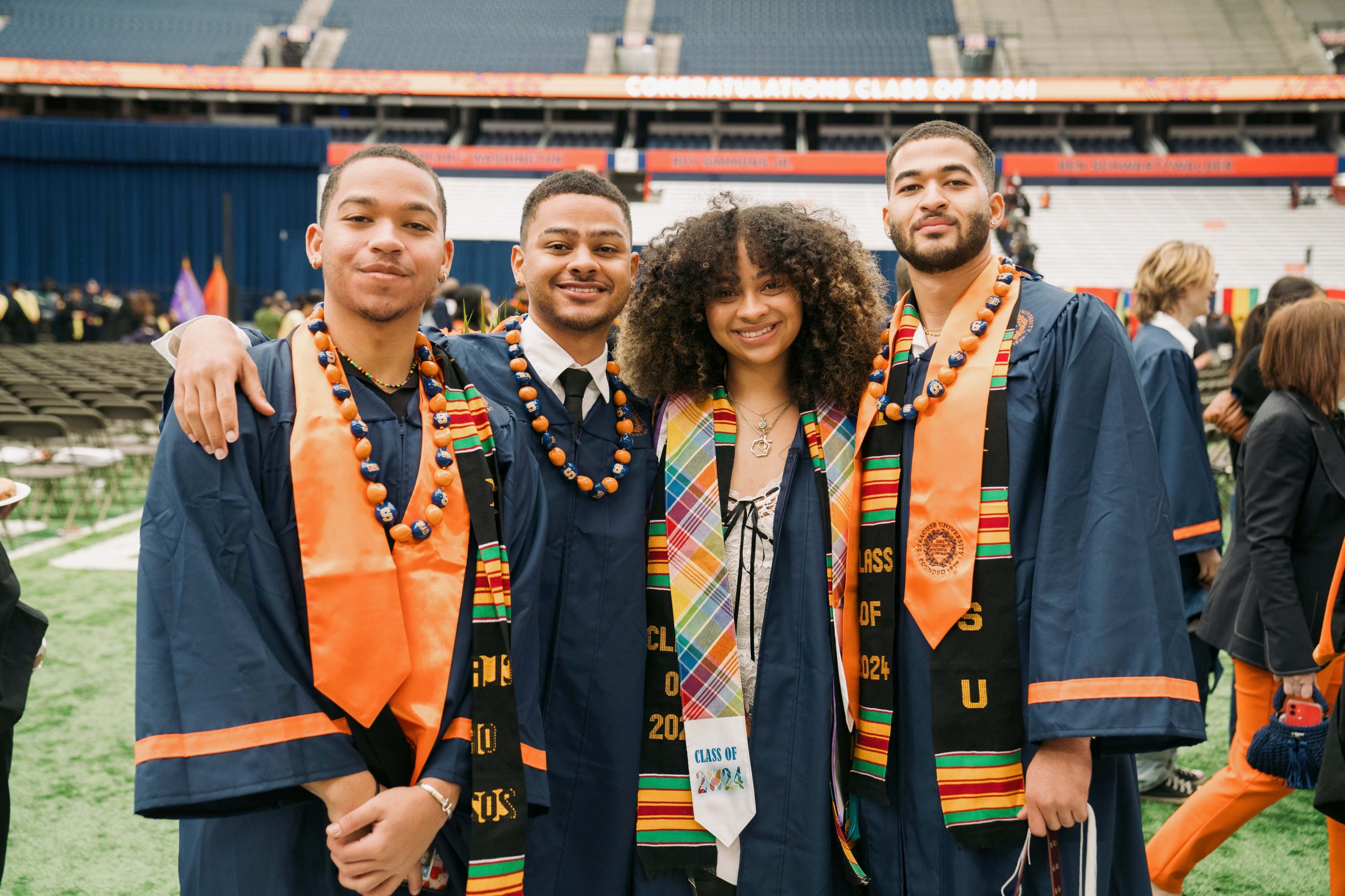 Four students standing together after Commencement 
