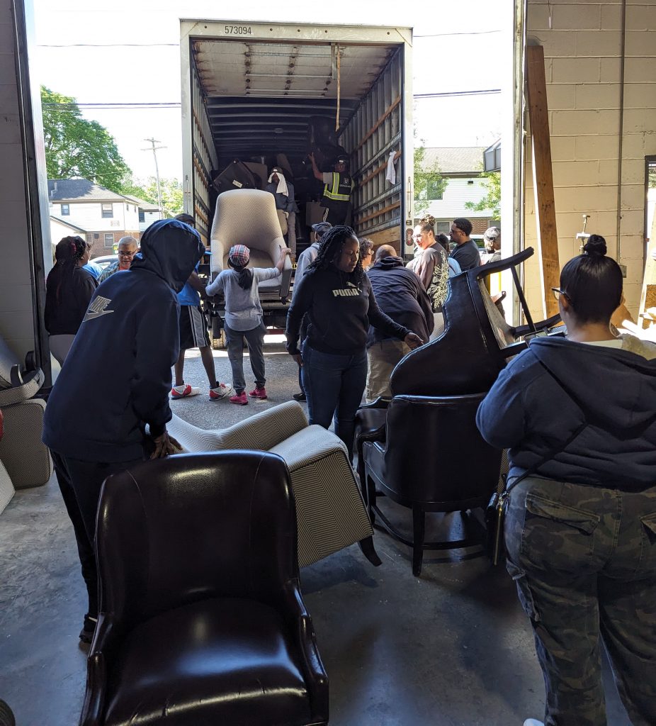 People loading furniture onto a truck
