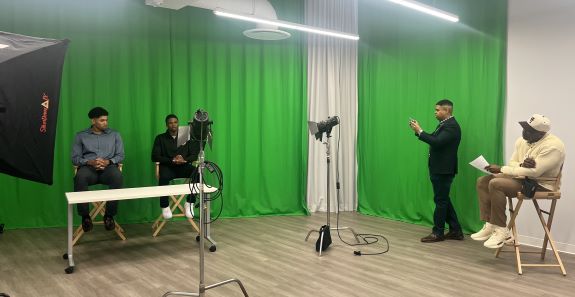 students learning broadcasting tactics in a green-screen room