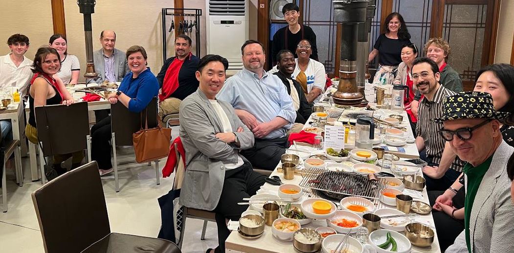 groups of faculty, students and university representatives enjoy a dinner