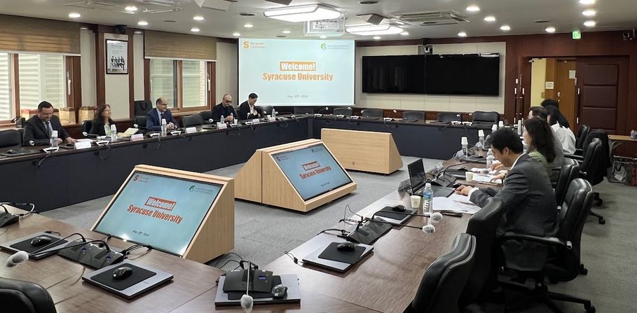 group of University representatives seated in a meeting