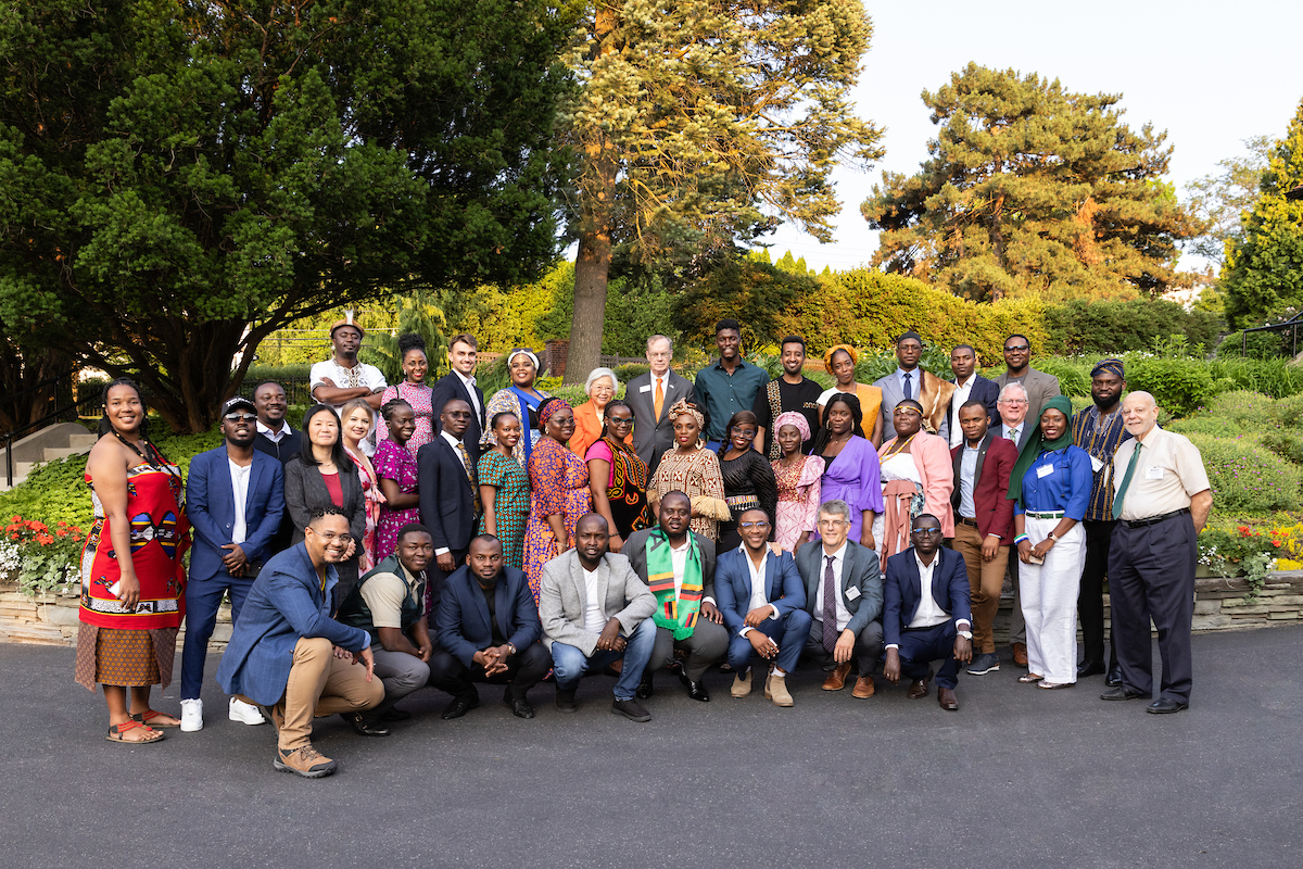 Large group of people all standing together outside posing for a photo.