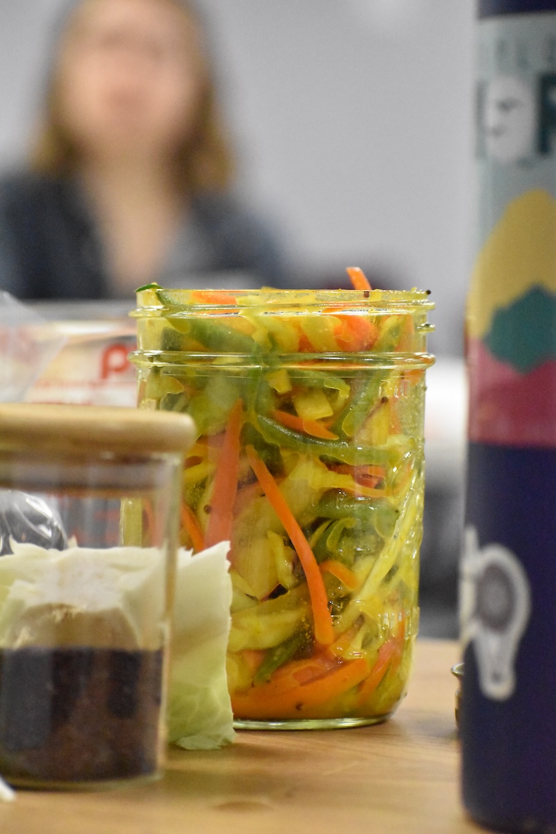 Glass jar full of vegetable mixture.