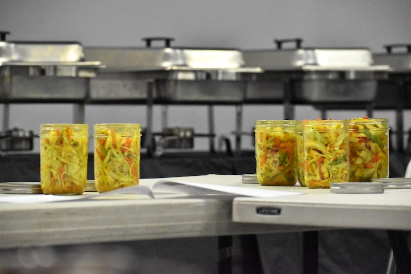 Six glass jars of vegetable mixture.