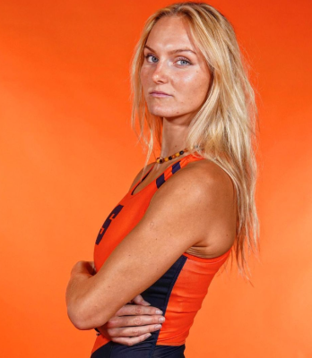 A woman poses for a headshot wearing her Orange Syracuse University rowing outfit.