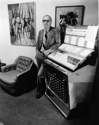 person standing next to a jukebox