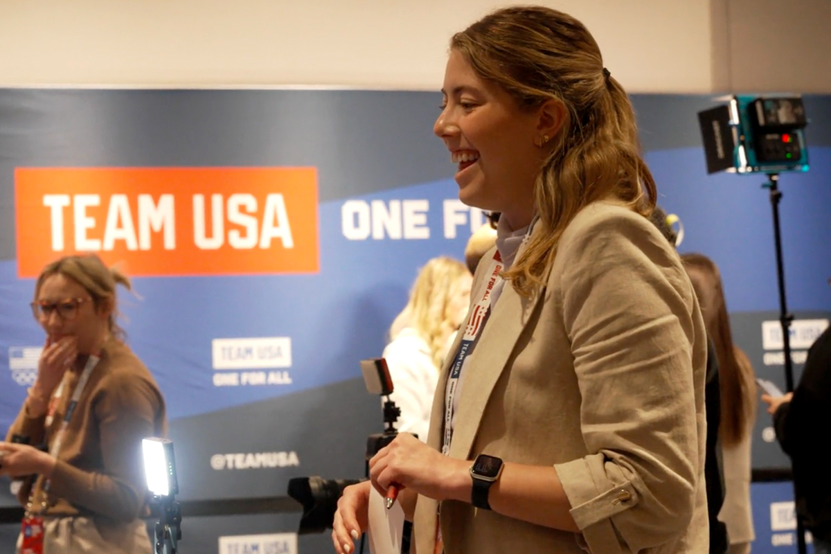 A woman smiles while conducting an interview at Team USA's headquarters.