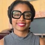 woman with hair pulled back and big black eyeglasses