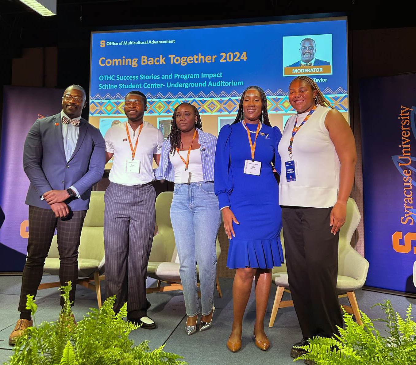 Five individuals pose together on stage during a panel discussion in Schine Underground during Coming Back Together 2024 alumni celebration