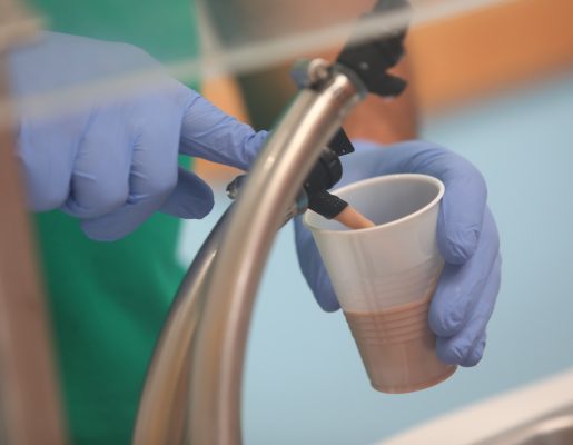 Chocolate milk being poured from a spout.