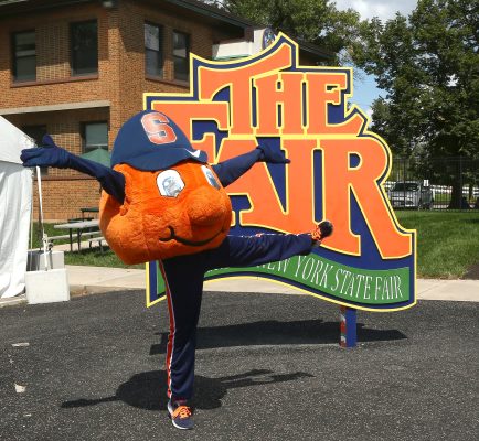 Otto the Orange in front of the Fair logo