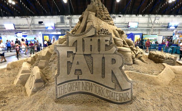 The Great New York State Fair logo etched into sand