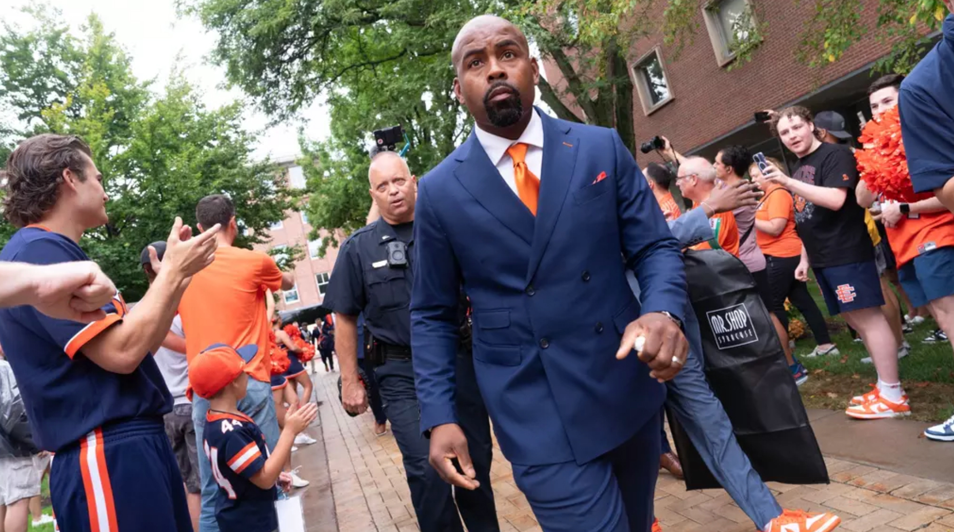 Coach Fran Brown marching through the Quad and a sea of fans during the very first Quad Walk.