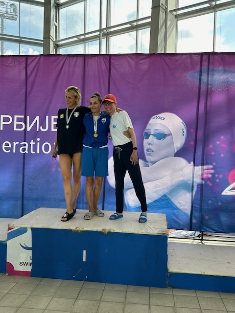 Three people standing together on a podium.