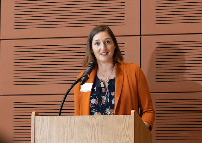 Physics professor M. Lisa Manning speaks at a podium