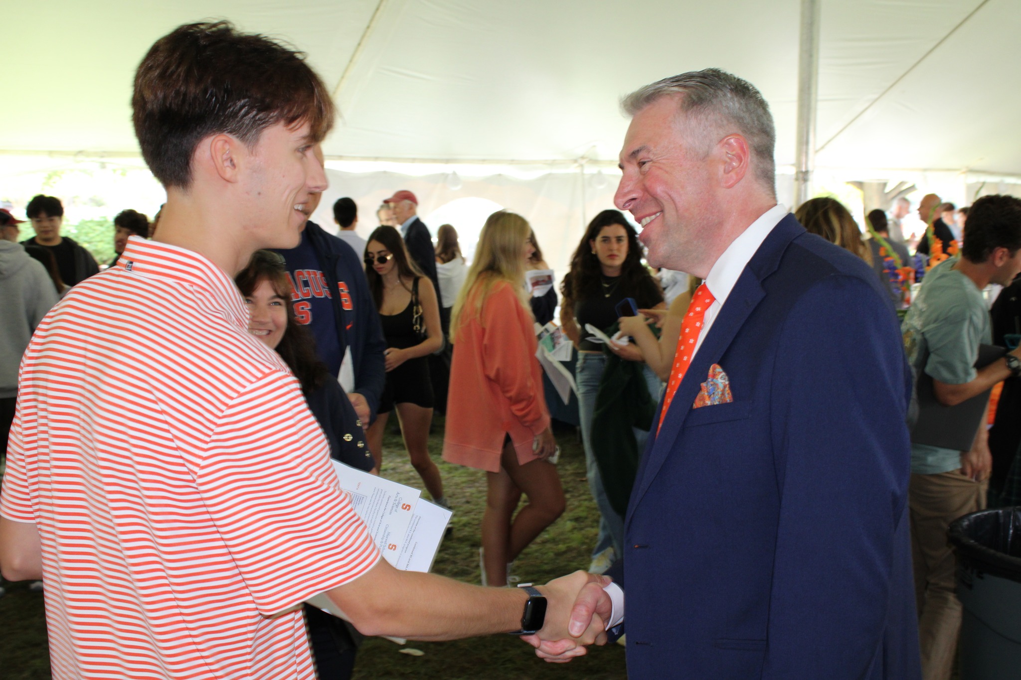 Two people shake hands.