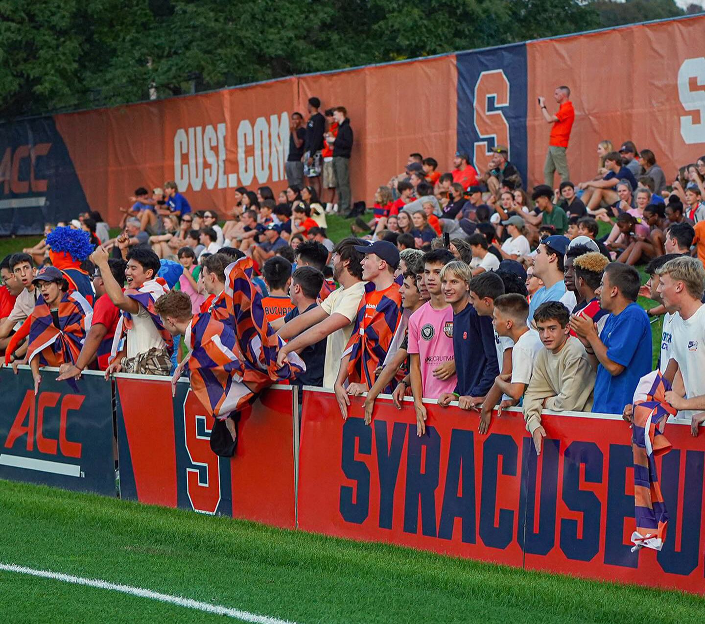 group of fans cheer on the Orange men's soccer team at the SU Soccer Stadium