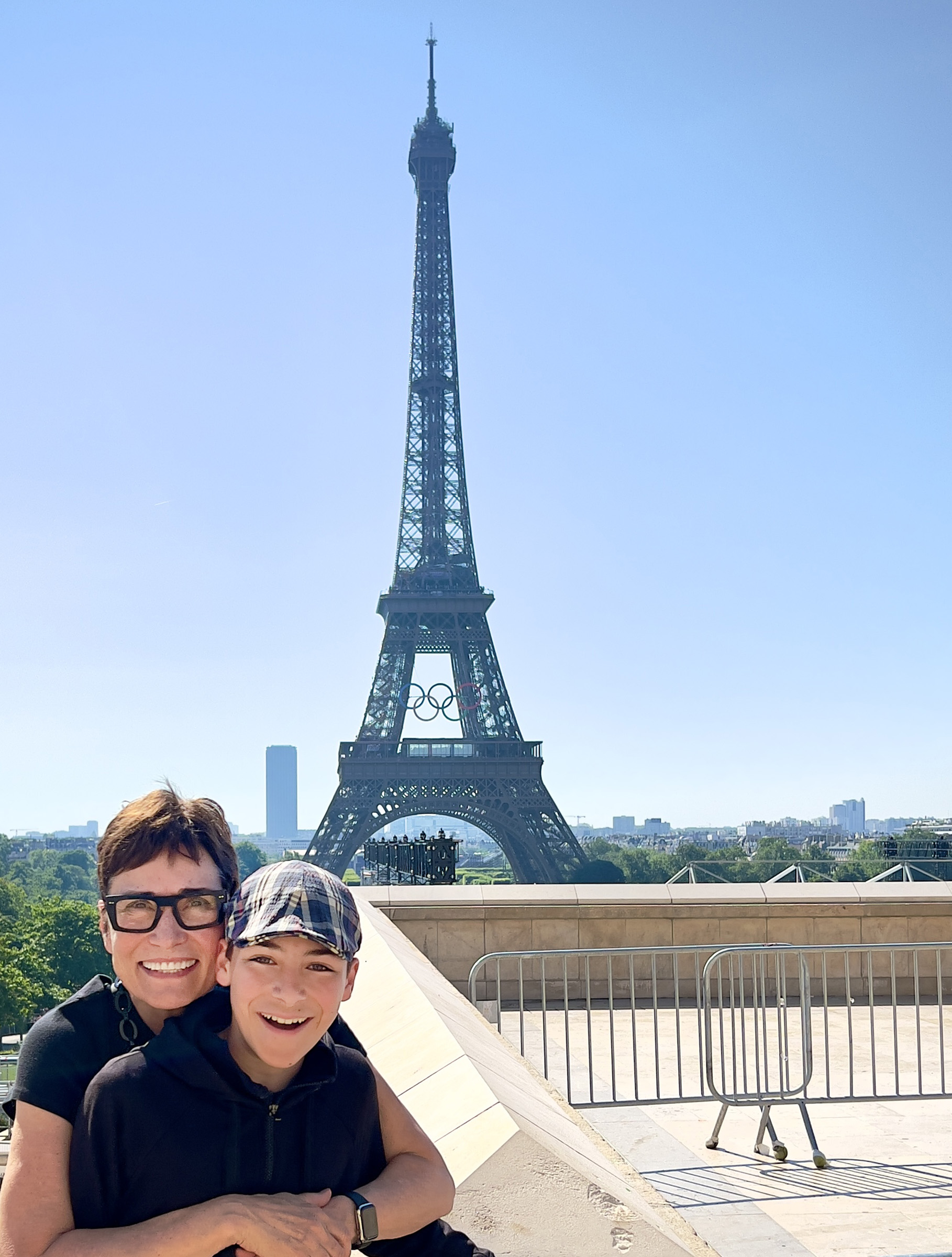 Two people standing together with the Eiffel Tower in the background.