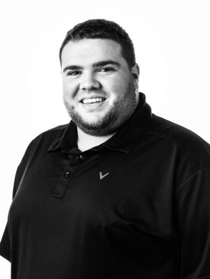 A man smiles while posing for a portrait photograph.