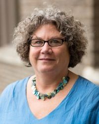 woman with glasses and blue shirt