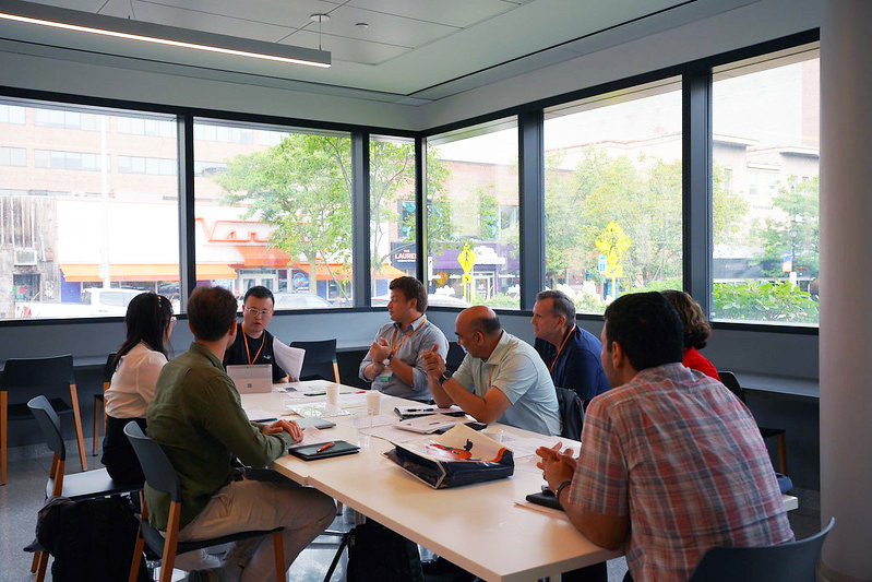 group of people sitting around conference table