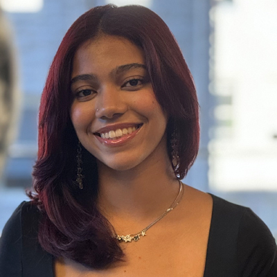 A woman smiles while posing for a headshot.