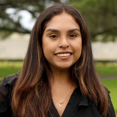 A woman smiles while posing for a headshot.